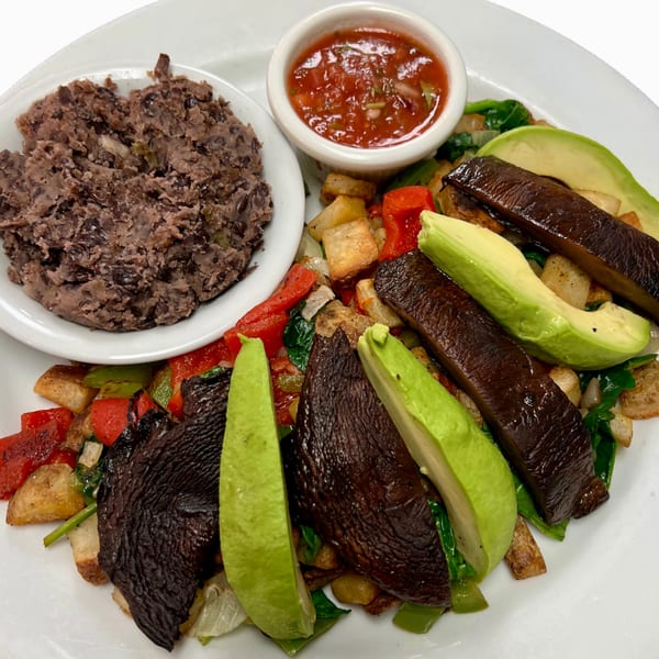 Sweet Berry Cafe's vegan breakfast with black beans, salsa, portobello mushrooms, avocado, and vegetables.